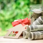 Model of house with Money growth coins Stacks on wooden table, Save and investment money for prepare in the future - Concept of finance investment.