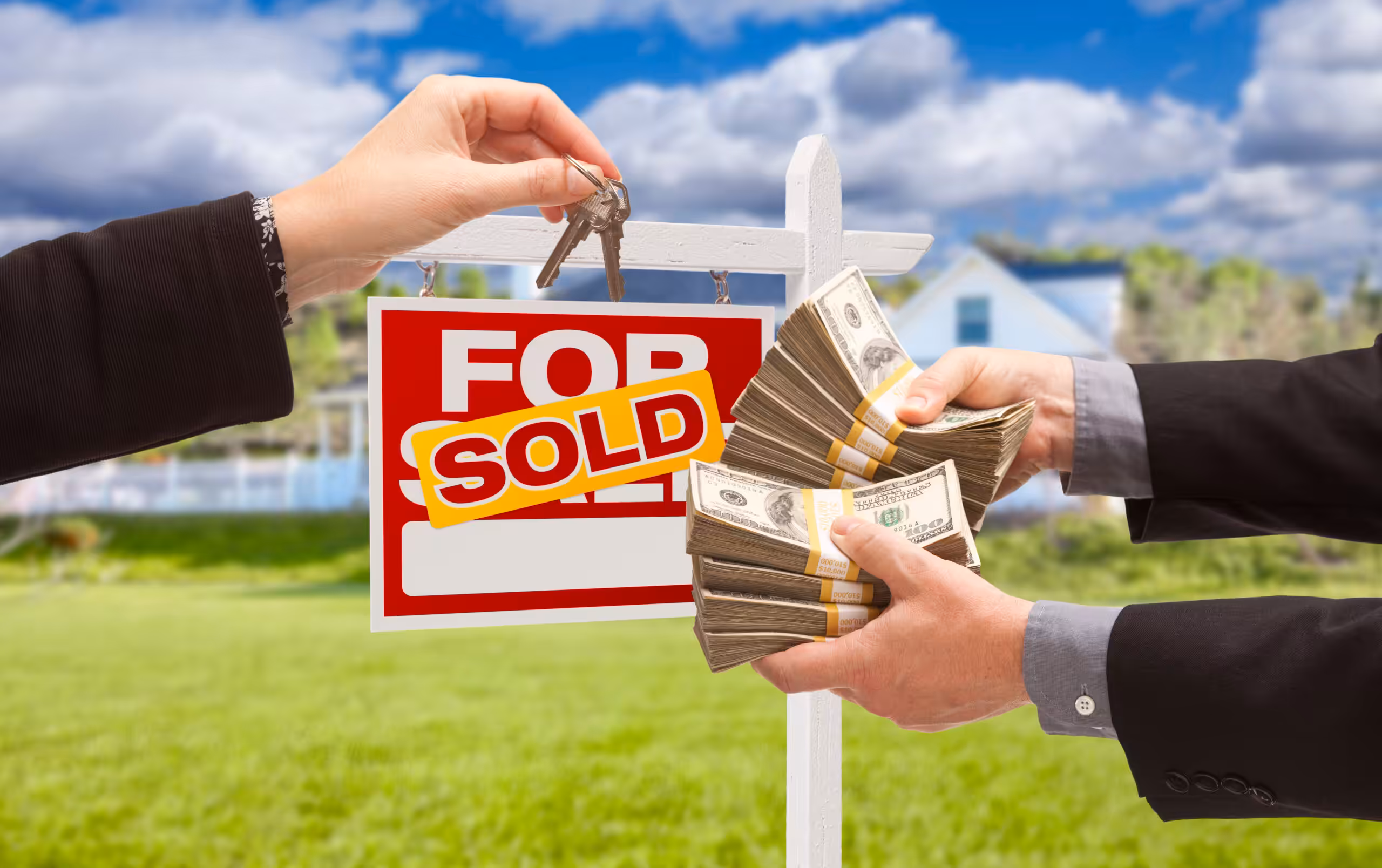 Man Handing Woman Thousands of Dollars For Keys in Front of House and Sold For Sale Real Estate Sign.